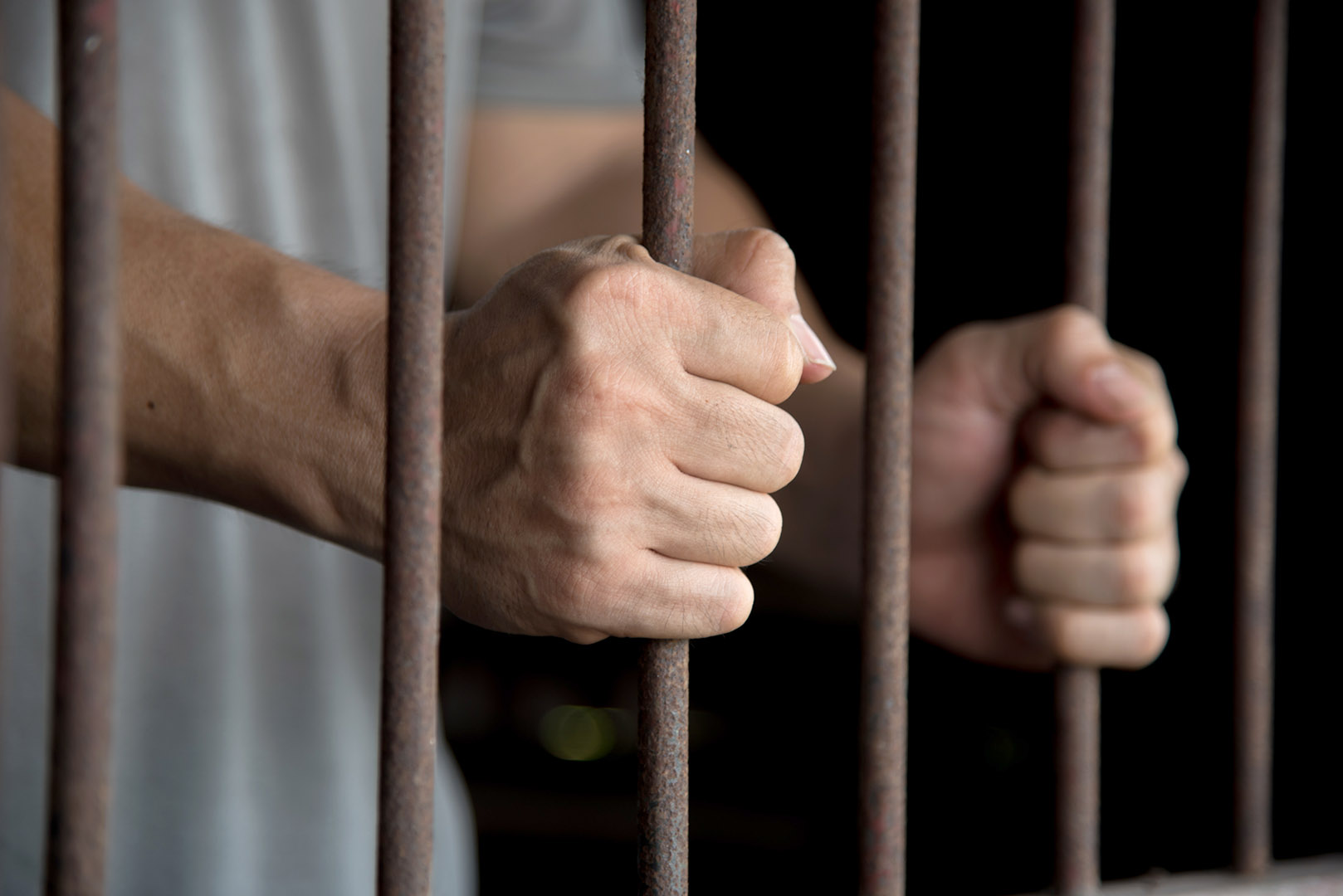 man holding prison bars photo